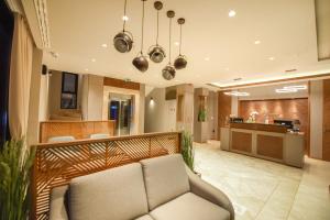 a living room with a couch and a kitchen at Hotel Union in Podgorica