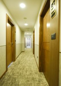an empty hallway in an office building with wooden doors at Hotel Union in Podgorica