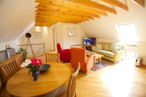 a living room with a table and a living room at Sebay Mill Holiday Apartments in Toab