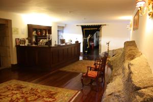 a living room filled with furniture and a fireplace at Hotel Convento Nossa Senhora do Carmo in Freixinho