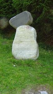 a large rock sitting in the grass at Haus Bergheim in Sankt Leonhard im Pitztal