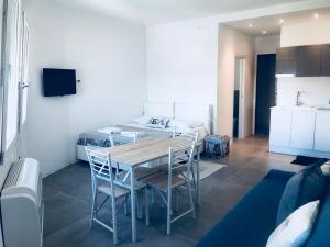 een kamer met een tafel en stoelen en een bed bij appartamento piazza mazzini in Lido di Jesolo