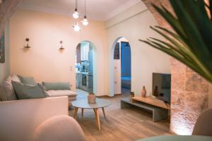 a living room with a couch and a tv at Traditional Thiseio Home in Athens