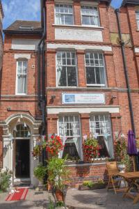 a brick building with flowers in front of it at Shearwater in Bridlington