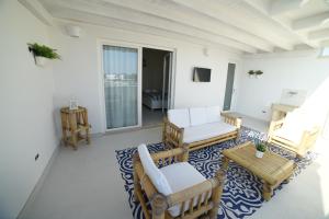 a living room with two chairs and a table at Latino Rent Room B&B vista mare in Porto Cesareo