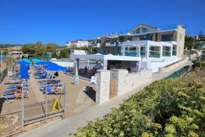 a resort with a pool and chairs and a building at Hellas Beach Hotel in Skaleta +6 photos
