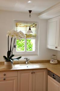 a kitchen with a sink and a window at Mas du Perthus in Cassis