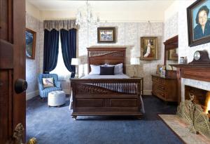 a bedroom with a bed and a fireplace at The Reynolds Mansion in Asheville