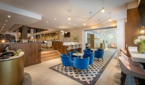 un restaurante con sillas azules y un bar en The Morgan Hotel en Dublín