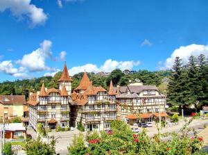 a large building with turrets on a mountain at Hotel Sky Gramado in Gramado