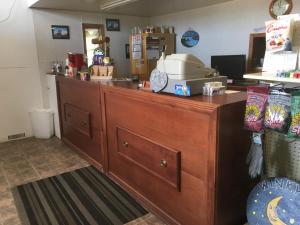 a kitchen with a counter with a cash register at Winkys Motel in Estevan