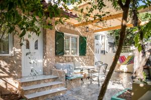 a patio with stairs and a table and chairs at Traditional Thiseio Home in Athens