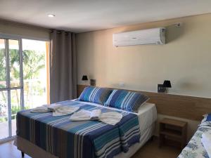 Cama ou camas em um quarto em Pousada Maresias Beira Mar