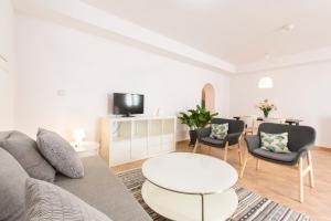 a living room with a couch and a table and chairs at Montes Claros 26 in Granada