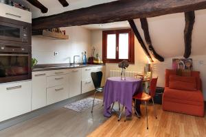 a kitchen with a table with a purple table cloth at Apartamento Ondarroa in Ondárroa