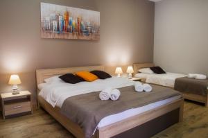 a hotel room with a bed and a lamp at Centar lux 2 in Zrenjanin