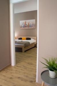 a bedroom with a bed and a table and a mirror at Centar lux 2 in Zrenjanin