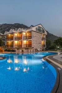 a large swimming pool in front of a building at Seyir Village Hotel in Oludeniz