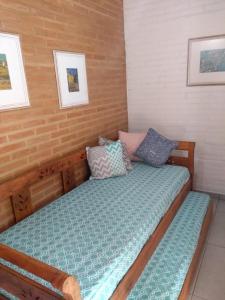 a bed with pillows on it in a room at Sítio do Sauá in Cunha