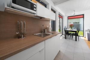 a kitchen with a sink and a counter top at Domki Morski Raj in Dębki