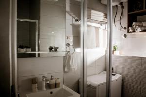 a white bathroom with a shower and a toilet at Apartman Dujmović in Split +54 photos