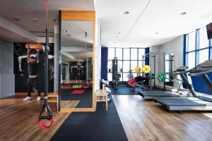 a gym with a man hanging from a hanging object at Garda Hotel in Montichiari