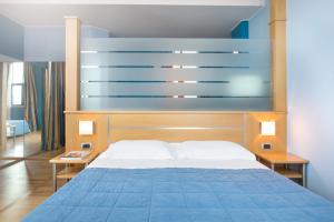 Postel nebo postele na pokoji v ubytování Garda Hotel