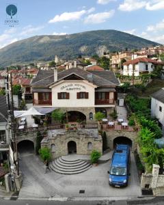 a blue car parked in front of a building at Grand Hotel Dentro in Konitsa