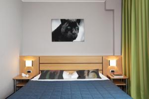 Postel nebo postele na pokoji v ubytování Garda Hotel