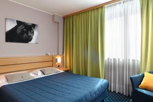 Postel nebo postele na pokoji v ubytování Garda Hotel