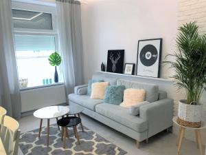 a living room with a couch and a table at Apartament BellaPola 2 in Nysa