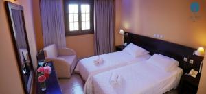 A bed or beds in a room at Grand Hotel Dentro