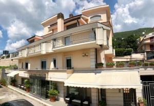 a large building with an awning in front of it at Hotel Sollievo - San Gennaro in San Giovanni Rotondo