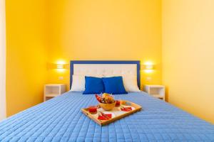 un letto blu con un vassoio di cibo sopra di B&B Trianon a Napoli