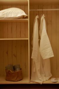 a closet with white towels and a bed at B&B - Racheli Bar-Lev in Had Nes