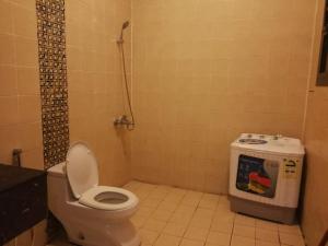 a bathroom with a toilet and a shower in it at Saad Palace Residential Units - Al Rabwa 2 in Abha +33 photos