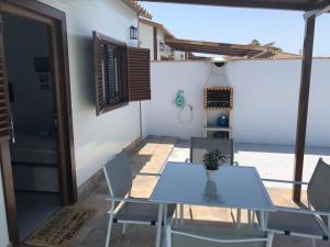 a table and chairs on a patio with a view of the ocean at Suites D'Elice in El Palmar