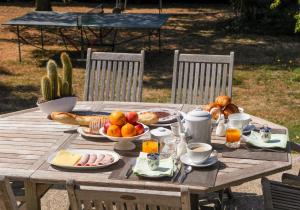 a wooden table with food on top of it at Clos des Ormes in Jargeau