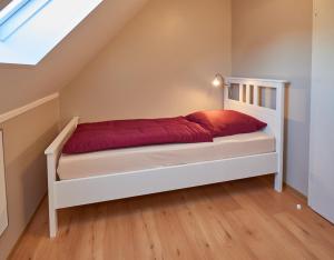 a bedroom with a white bed in a attic at Ferienwohnung Haaren in Waldfeucht