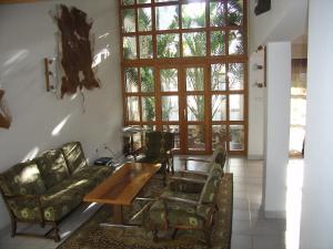a living room with a couch and a table at Pálma Apartmanház Harkány in Harkány