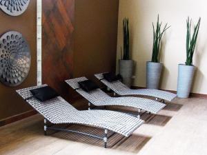a row of chairs in a room with plants at Hotel Itapemar - Ilhabela in Ilhabela