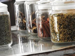 a group of glass jars filled with different types of food at Hotel Itapemar - Ilhabela in Ilhabela