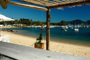 a view of a beach with boats in the water at Hotel Itapemar - Ilhabela in Ilhabela