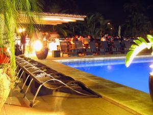 a swimming pool at a resort at night at Hotel Itapemar - Ilhabela in Ilhabela
