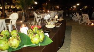 a table with a bunch of food on it at Hotel Itapemar - Ilhabela in Ilhabela