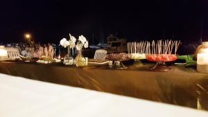 a table with plates of food and candles on it at Hotel Itapemar - Ilhabela in Ilhabela