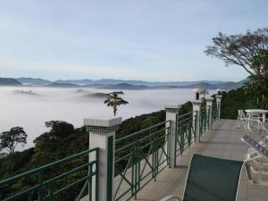 ランバリにあるPousada Lambari Montanha Hotelの海の景色を望むバルコニー(椅子付)