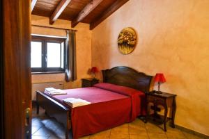 a bedroom with a bed and a desk and a window at Agriturismo U' Casinu dà Scala in Campora San Giovanni