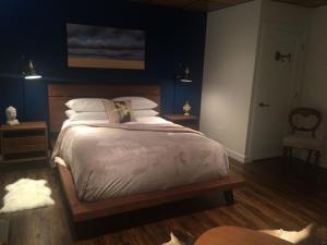 a bedroom with a large bed with blue walls at Spa inspired guest suite in Jasper