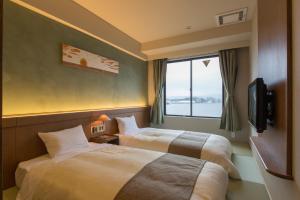 Matsue New Urban Hotel tesisinde bir odada yatak veya yataklar